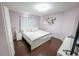 Comfortable bedroom showcasing a queen bed and warm, inviting light at 14415 Estrella Dr, Orlando, FL 32837