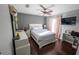 Cozy bedroom featuring a queen bed, dark hardwood floors, and soft natural lighting at 14415 Estrella Dr, Orlando, FL 32837
