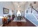Bright dining room with tall ceilings, wood floors, and decorative mirror over faux fireplace at 14415 Estrella Dr, Orlando, FL 32837