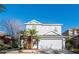 Charming two-story home featuring a well-manicured lawn and an attached two-car garage at 14415 Estrella Dr, Orlando, FL 32837