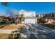 Charming two-story home with a well-manicured front yard and attached two-car garage on a sunny day at 14415 Estrella Dr, Orlando, FL 32837