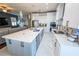 Open kitchen design featuring white cabinets, oversized island with seating, and stainless appliances at 14415 Estrella Dr, Orlando, FL 32837