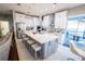 Modern kitchen with a large central island, stainless steel appliances, and sleek white cabinetry at 14415 Estrella Dr, Orlando, FL 32837