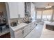 Well-lit kitchen with white cabinetry, stainless steel appliances, marble countertops and flooring at 14415 Estrella Dr, Orlando, FL 32837