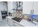 The kitchen features stainless steel appliances, white cabinets, and a unique backsplash at 14415 Estrella Dr, Orlando, FL 32837
