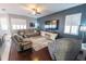Comfortable living room with plush seating, a large TV, and plantation shutters for a cozy atmosphere at 14415 Estrella Dr, Orlando, FL 32837