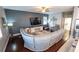 Spacious living room with hardwood floors, a gray couch, a large TV, and a ceiling fan at 14415 Estrella Dr, Orlando, FL 32837