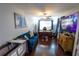Comfortable home office or living room with dark wood floors, neutral paint, and blue sofa at 14415 Estrella Dr, Orlando, FL 32837