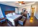 Spacious main bedroom with a dark wood furniture set, tray ceiling, and hardwood flooring at 14415 Estrella Dr, Orlando, FL 32837