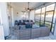 Screened-in patio with comfortable outdoor seating and modern decor at 14415 Estrella Dr, Orlando, FL 32837