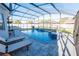 Backyard pool with ample lounge space is encased in a screened enclosure, perfect for enjoying sunny days at 14415 Estrella Dr, Orlando, FL 32837