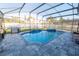 Enclosed pool area featuring a luxurious in-ground pool, spa, and modern patio at 14415 Estrella Dr, Orlando, FL 32837