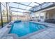 Enclosed pool area with a luxurious in-ground pool, hot tub, and a modern patio at 14415 Estrella Dr, Orlando, FL 32837