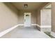 Inviting front entrance featuring a classic white door with glass detailing, sheltered by a covered porch with neutral tones at 16060 Sw 21St Terrace Rd, Ocala, FL 34473