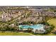 Aerial view of community pool and surrounding residences, showcasing lush landscaping and resort-style amenities at 16133 Pebble Bluff Loop, Winter Garden, FL 34787