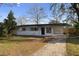 Charming single-story home with a covered parking and a well-maintained front yard at 17 Fanfair Ave, Orlando, FL 32811