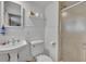 Cozy white bathroom with tiled shower, toilet, and pedestal sink with chrome hardware at 1721 Cheyenne Trl, Maitland, FL 32751