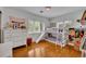 Bright bedroom featuring a bunk bed with slide and large windows with views of lush greenery at 1721 Cheyenne Trl, Maitland, FL 32751