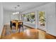 Bright dining room with modern chandelier, hardwood floors and view to the private outdoor area at 1721 Cheyenne Trl, Maitland, FL 32751