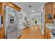 Modern kitchen with stainless steel appliances, wood cabinets and an adjoining eat-in area at 1721 Cheyenne Trl, Maitland, FL 32751