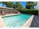 Private backyard pool surrounded by a brick patio and a wood fence at 1721 Cheyenne Trl, Maitland, FL 32751