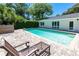 Backyard pool with a lounge chair and a brick patio, perfect for relaxing and entertaining at 1721 Cheyenne Trl, Maitland, FL 32751