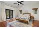 Well-lit bedroom with hardwood floors and convenient access to the backyard through French doors at 1731 Windsor Dr, Winter Park, FL 32789