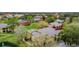 An aerial view of residential houses featuring lush surroundings, tennis court and a green lawn at 184 Villa Di Este Ter # 200, Lake Mary, FL 32746