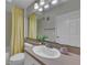 Bathroom with shower and tub, light countertop, oval sink, and modern lighting fixture at 193 Longview Ave # 104, Kissimmee, FL 34747