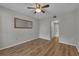Bedroom with a ceiling fan, mirror, and neutral-colored walls at 193 Longview Ave # 104, Kissimmee, FL 34747