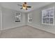 Bedroom with carpet, neutral walls, ceiling fan, and natural light from large windows at 193 Longview Ave # 104, Kissimmee, FL 34747