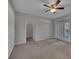 Bedroom featuring a ceiling fan, closet, and access to the outdoors at 193 Longview Ave # 104, Kissimmee, FL 34747