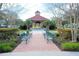 Inviting community park featuring a covered gazebo, brick walkways, seating, and beautiful landscaping at 193 Longview Ave # 104, Kissimmee, FL 34747