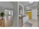 Modern kitchen featuring stainless steel appliances, granite countertops, and bright yellow accent wall at 193 Longview Ave # 104, Kissimmee, FL 34747