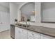 Modern kitchen with stainless steel dishwasher, granite countertops and open view to the living room at 193 Longview Ave # 104, Kissimmee, FL 34747