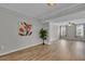 Open-concept living room boasts wood floors, neutral paint, and natural light from large windows at 193 Longview Ave # 104, Kissimmee, FL 34747