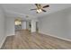 Spacious living room showcasing modern finishes, a ceiling fan, and hardwood floors at 193 Longview Ave # 104, Kissimmee, FL 34747