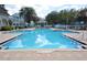 Sparkling swimming pool with surrounding deck, umbrellas, and lounge chairs at 193 Longview Ave # 104, Kissimmee, FL 34747