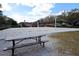 Outdoor sand volleyball court with picnic table and net ready for a game at 193 Longview Ave # 104, Kissimmee, FL 34747