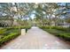 Scenic sidewalk path lined with lush trees and landscaping at 193 Longview Ave # 104, Kissimmee, FL 34747