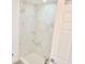 Bathroom featuring a modern, tiled shower with glass enclosure and a white tiled shower floor at 20660 Se 155Th St, Umatilla, FL 32784