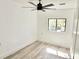 Cozy bedroom featuring a ceiling fan, light gray flooring, and a window for natural light at 20660 Se 155Th St, Umatilla, FL 32784