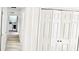 Hallway with new flooring leads to laundry room; storage closet features white doors and bronze knobs at 20660 Se 155Th St, Umatilla, FL 32784