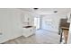 Bright kitchen with white cabinets, wood countertops, stainless steel refrigerator, and sliding glass door to the backyard at 20660 Se 155Th St, Umatilla, FL 32784