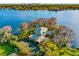 Breathtaking aerial view of the waterfront property, including the main house and tennis court at 2118 Lake Dr, Winter Park, FL 32789