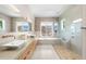 This bathroom features a stone surround soaking tub, double sink vanity and walk-in shower at 2118 Lake Dr, Winter Park, FL 32789
