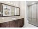 Bathroom with dark wood vanity, stone countertop and a glass enclosed shower at 2118 Lake Dr, Winter Park, FL 32789