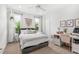 Bright bedroom with large windows, a cozy bed, and a functional workspace at 2118 Lake Dr, Winter Park, FL 32789