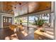 Covered outdoor patio with a dining area, built-in grill, and wood ceiling at 2118 Lake Dr, Winter Park, FL 32789