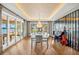 A dining room with modern lighting, beautiful hardwood floors, and a beautiful view of the lake at 2118 Lake Dr, Winter Park, FL 32789